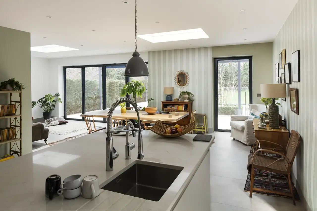 Modern kitchen with VELUX roof window and large glass doors.