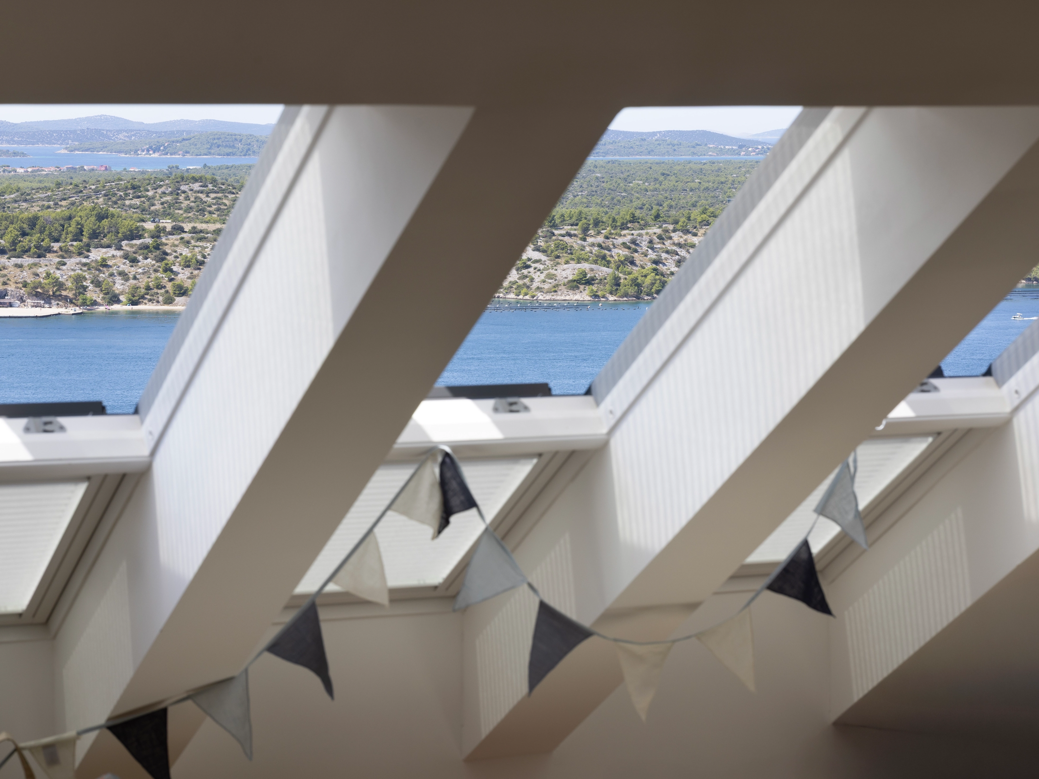 Attic room with VELUX roof windows and sea view.