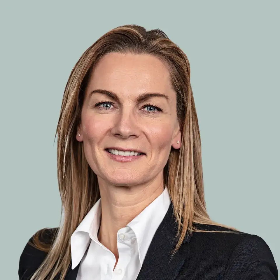 Woman in business suit with black blazer and white shirt.
