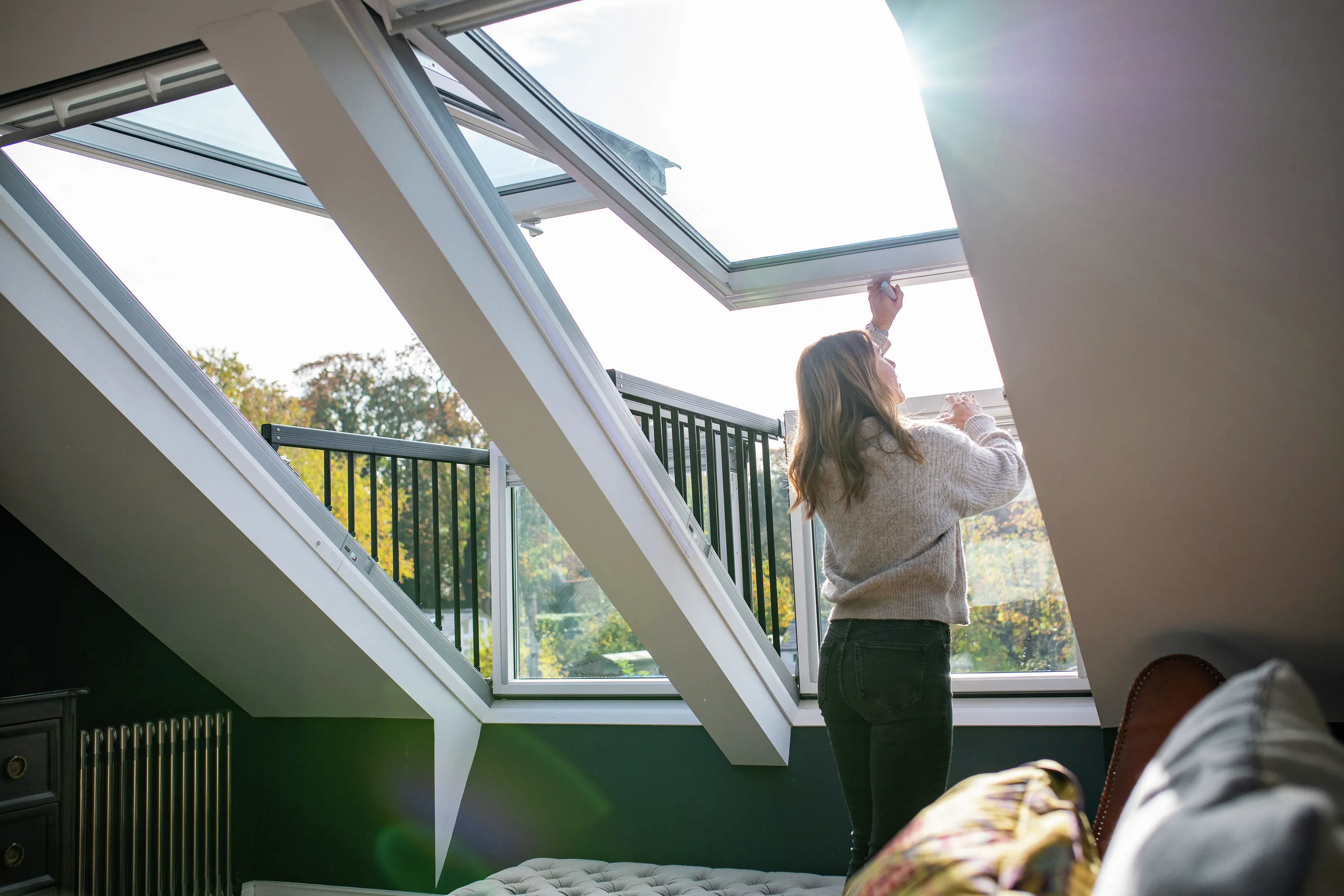 Podkrovná izba s dvoma strešnými balkónmi VELUX. O bezpečnosť sa stará bočné zábradlie.