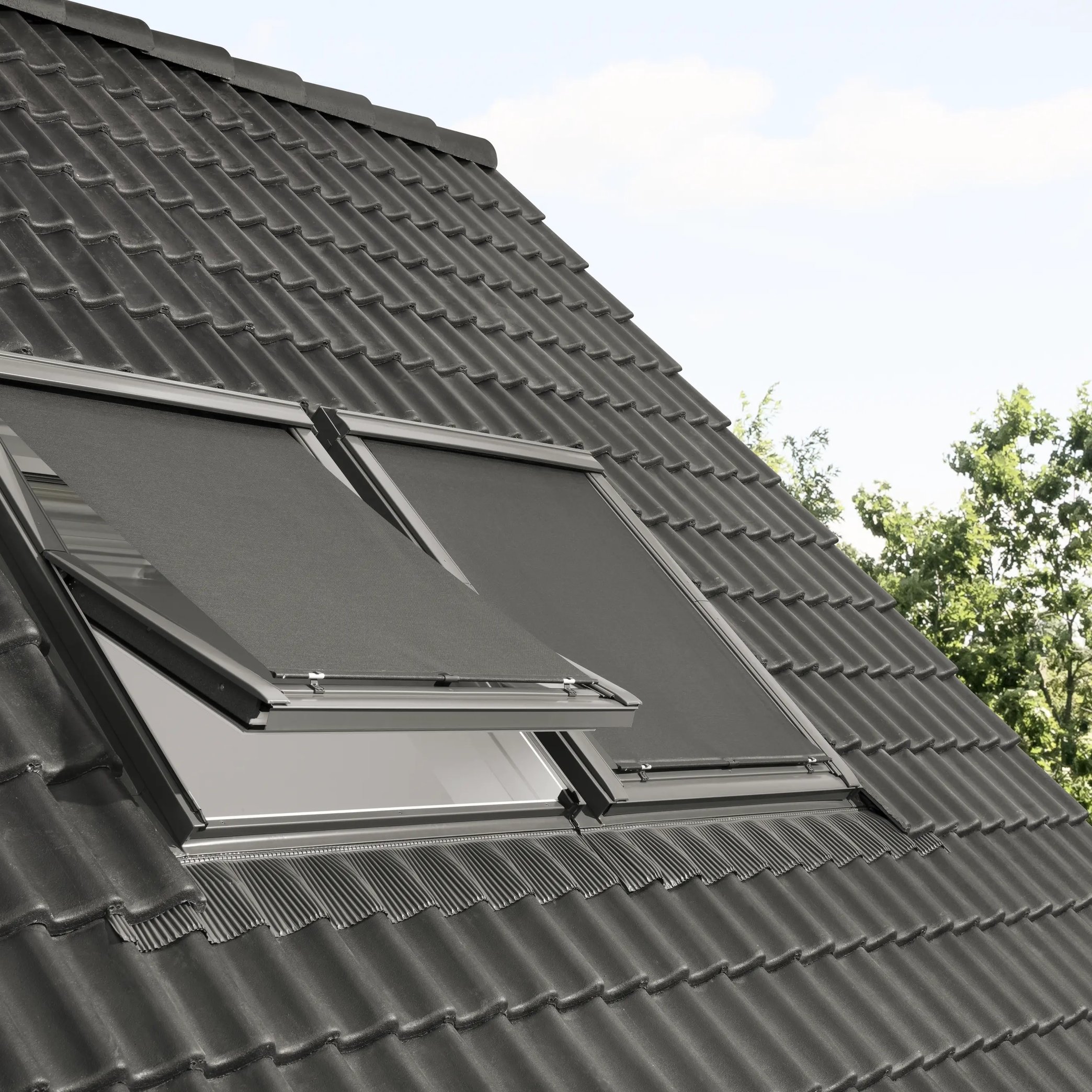 Modern roof with black tiles and open VELUX roof window.