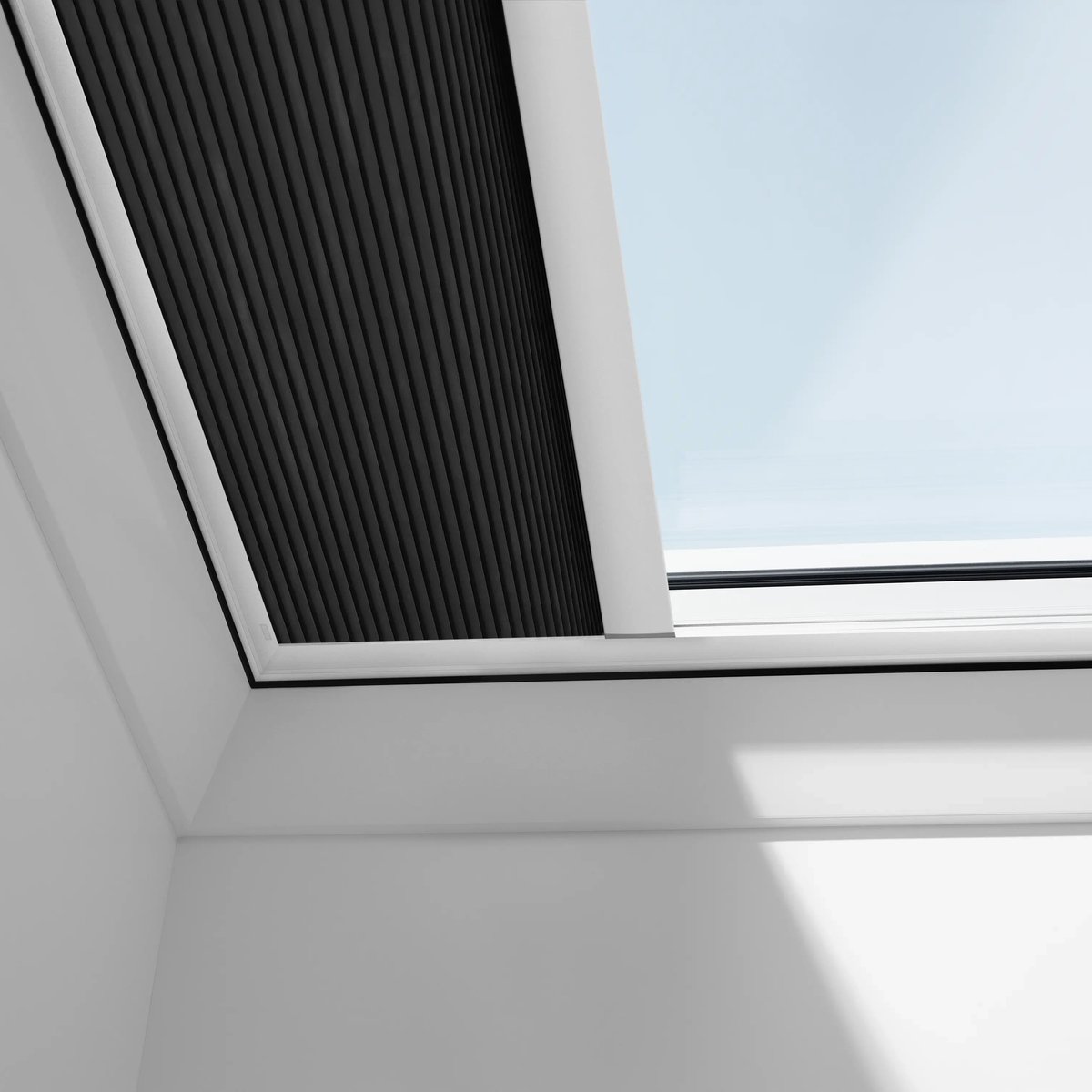 VELUX roof window with integrated blinds on a sloped ceiling.