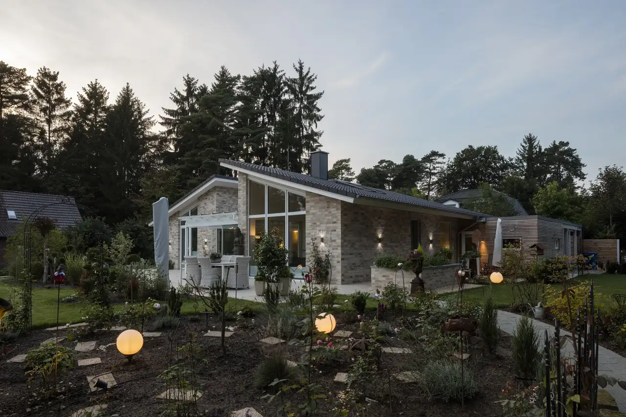 Extérieur d’une maison individuelle éclairée au crépuscule. 