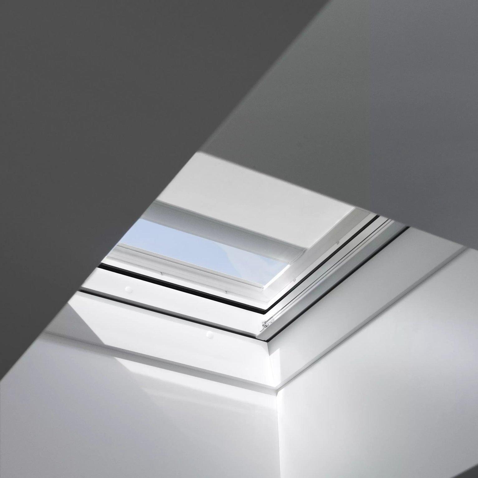 VELUX roof window in a modern interior, high on sloped ceiling.
