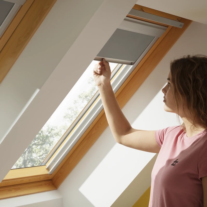 Attic room with VELUX roof window, natural light entering.