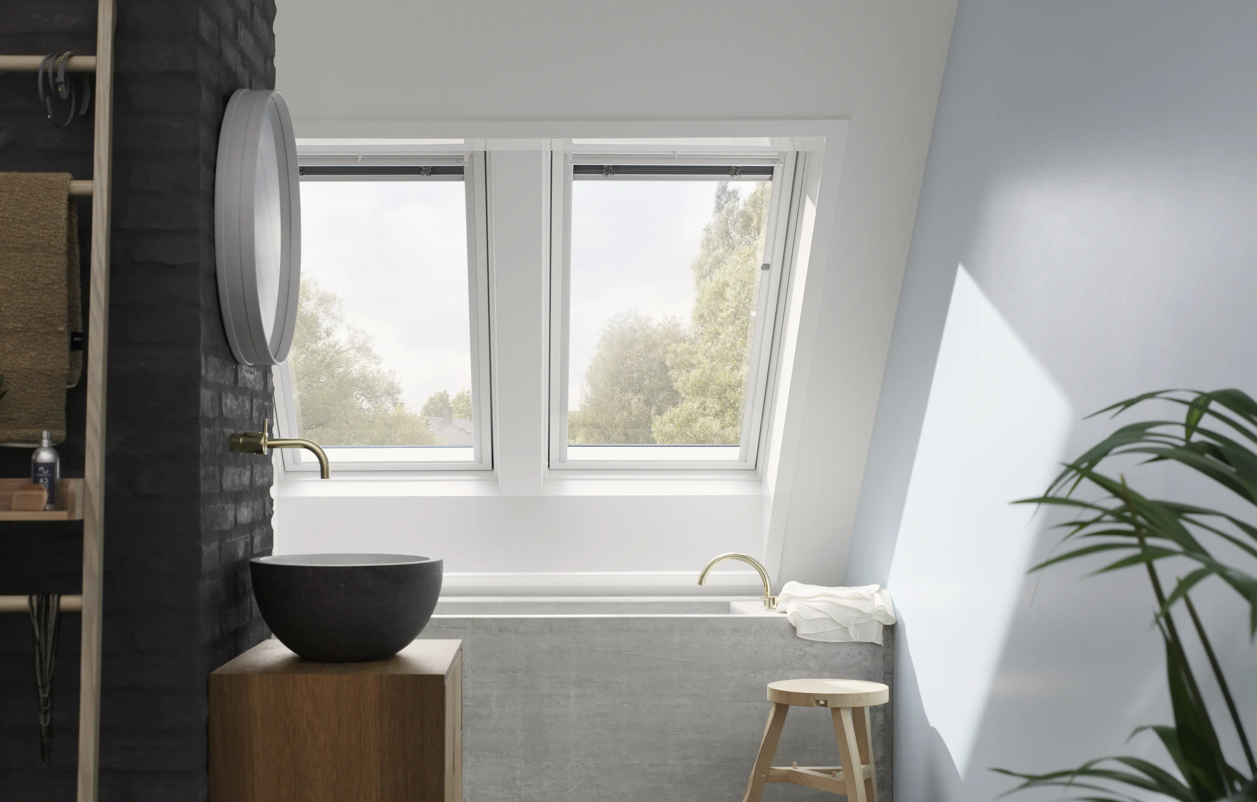 Bathroom with VELUX roof windows, stone basin, and modern bathtub.