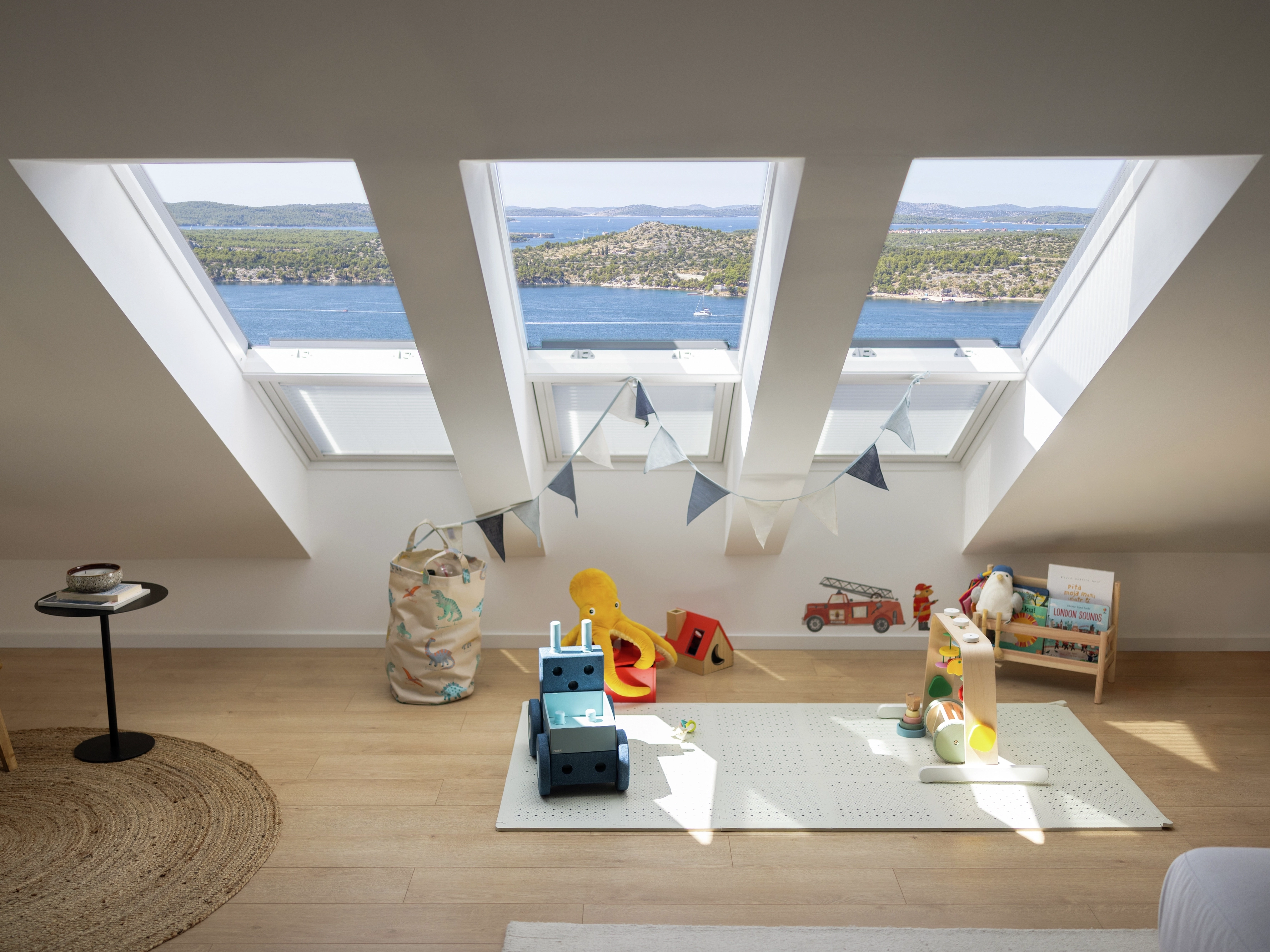Attic playroom with VELUX roof windows and toys.