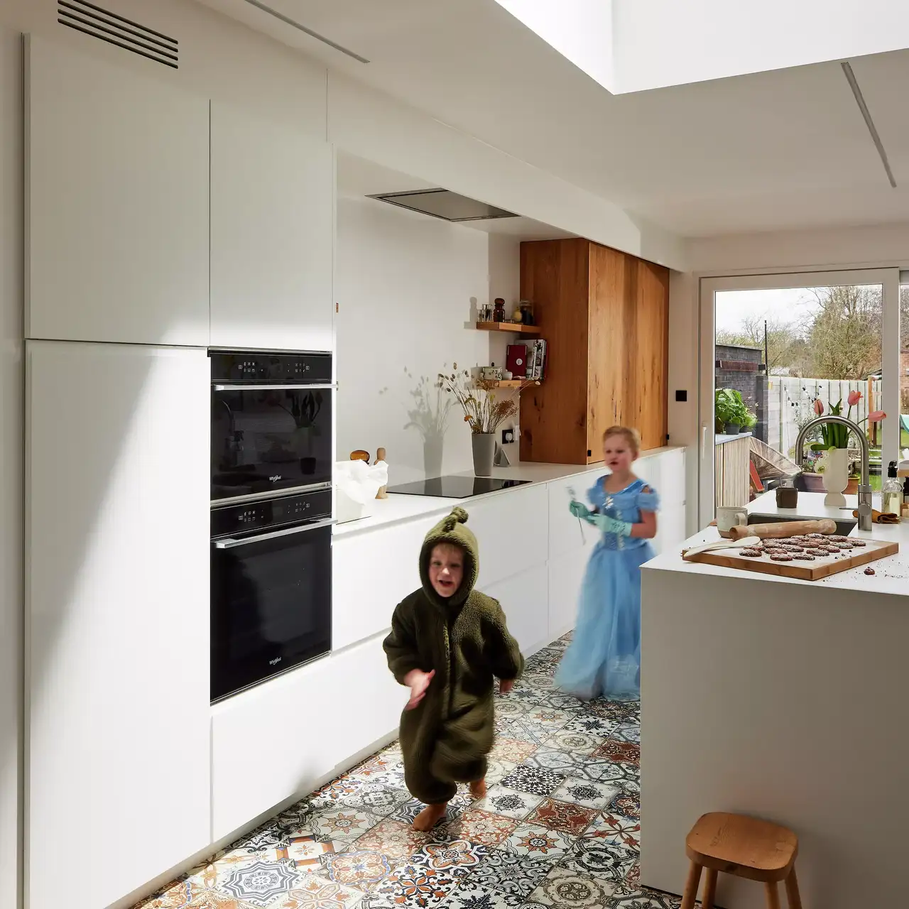 Kinder laufen in der Küche mit VELUX Flachdachfenster