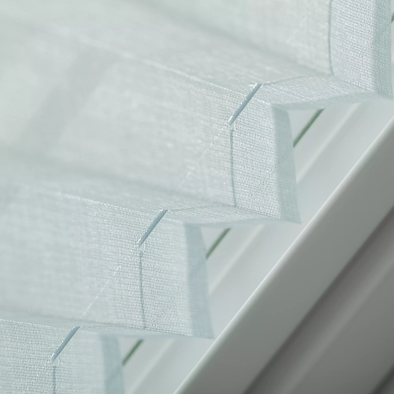 Close-up of window blinds with fabric texture and slats alignment.