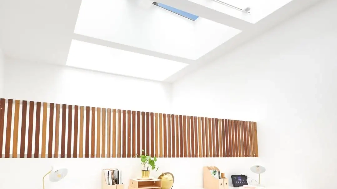Home office with flat roof windows and modern decor.