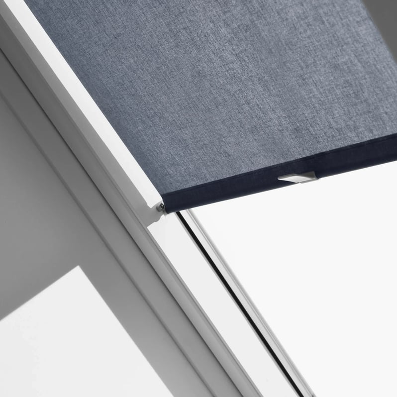 VELUX roof window with dark fabric blind, high ceiling position.