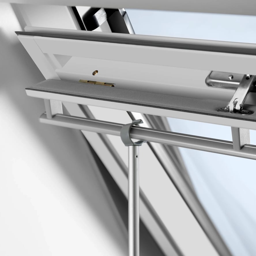 Open VELUX roof window with modern design, allowing light and air.