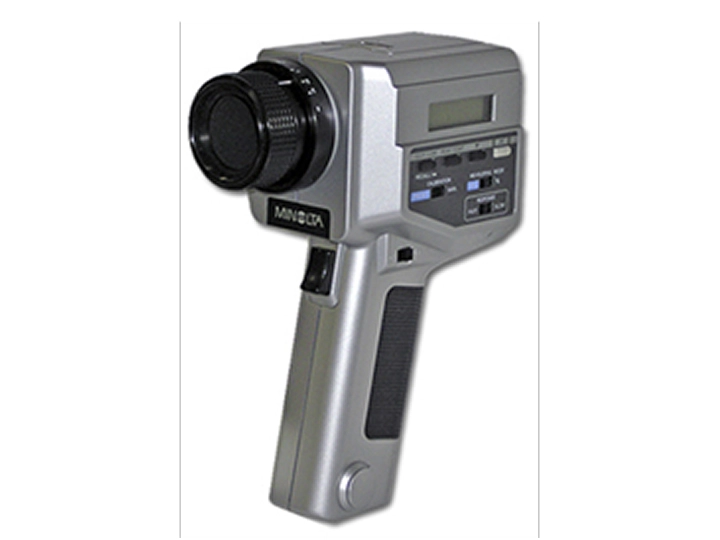 Minolta light meter with digital display and ergonomic handle.