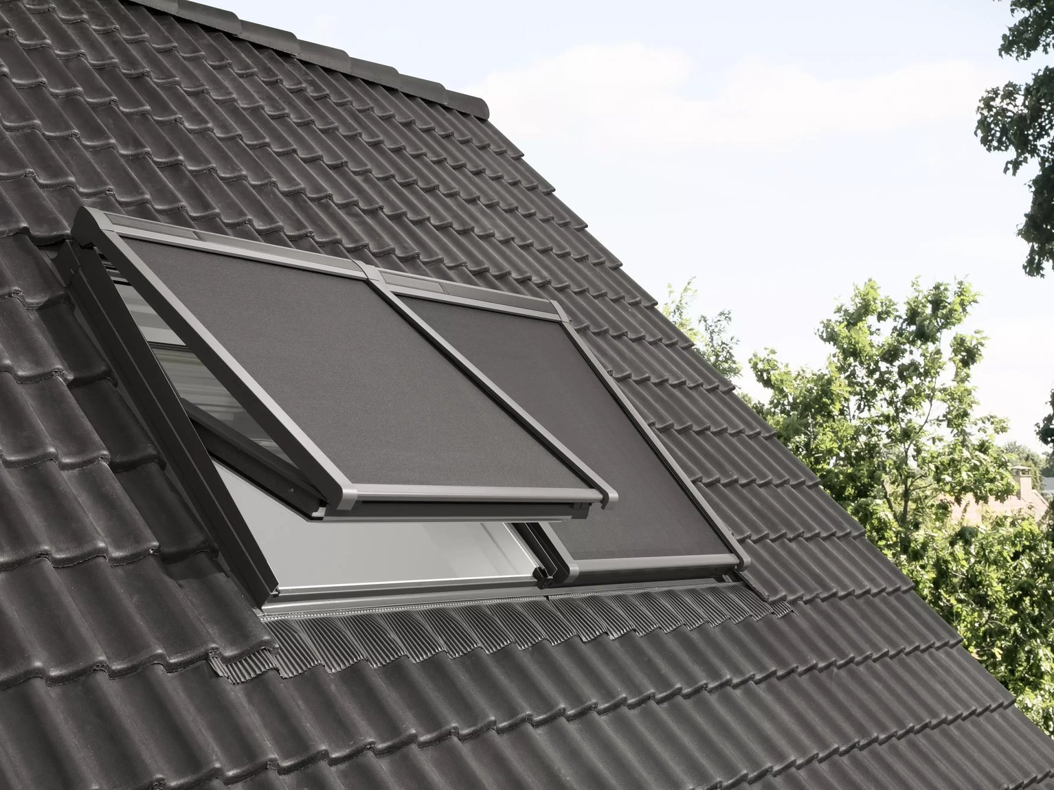 Roof with dark tiles and a partially open VELUX window.