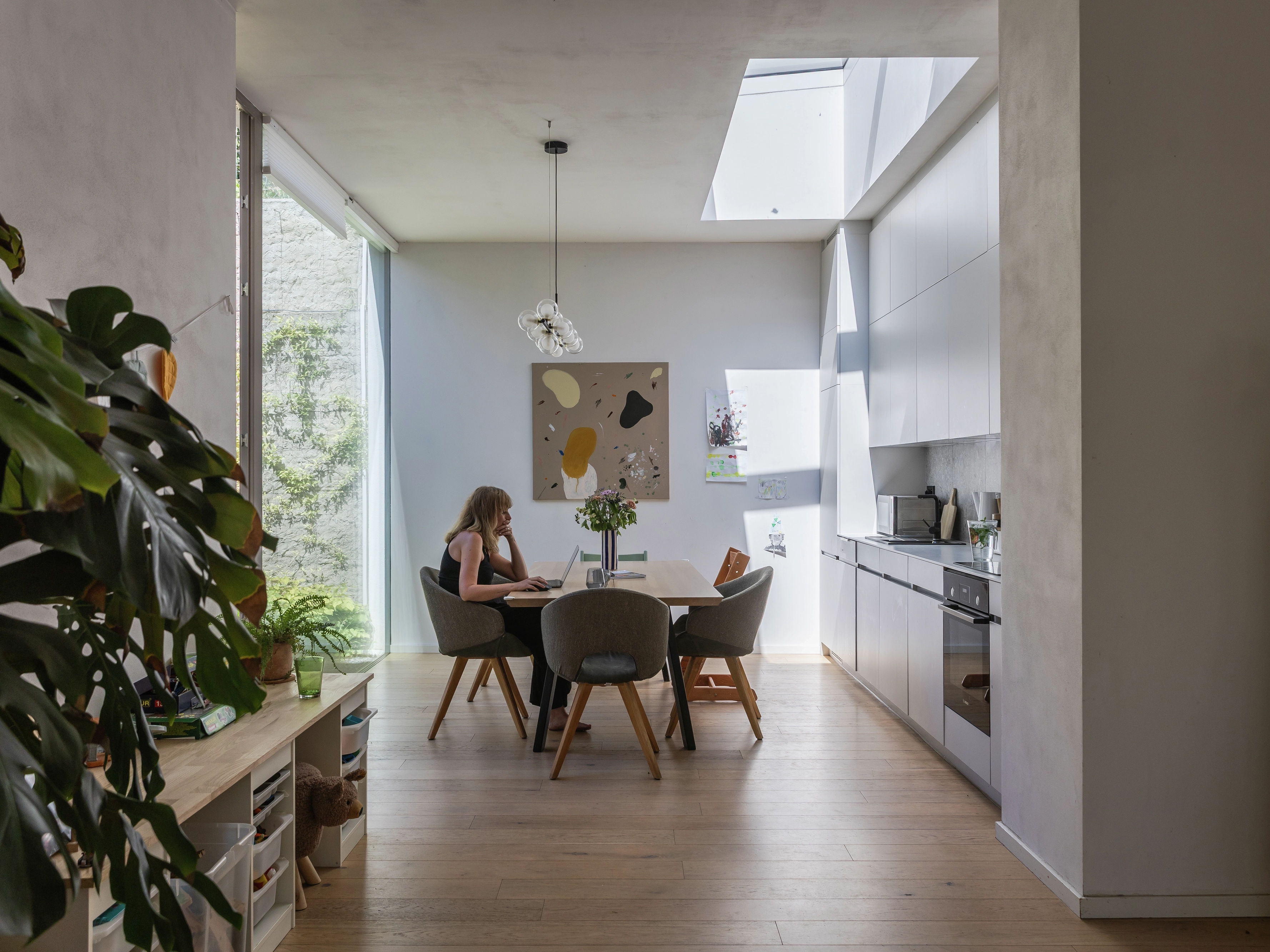 Dining area with skylight and modern kitchen.