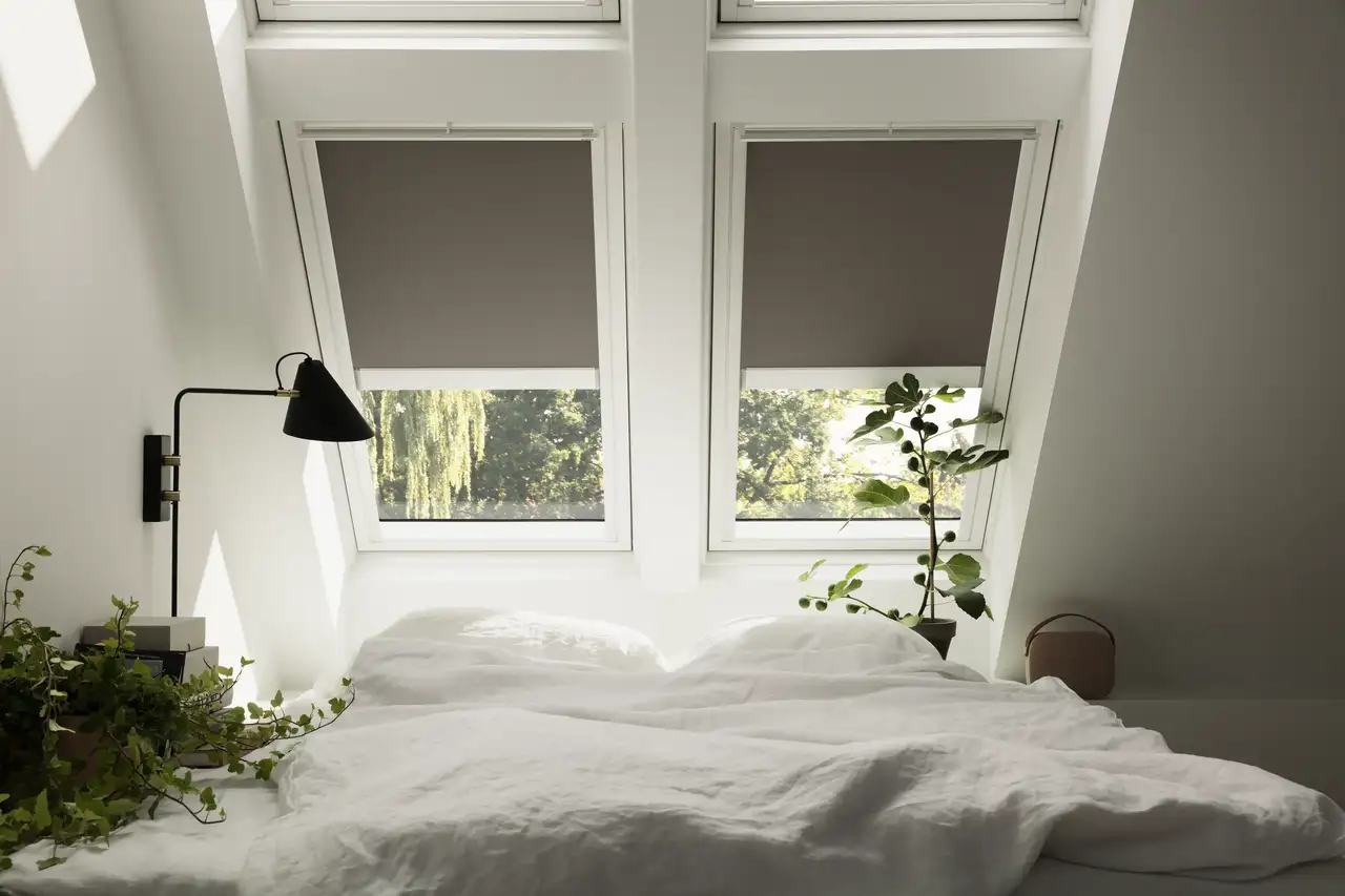 Kuscheliges Bett unter vier Dachfenstern mit Sonnenschutz | VELUX Magazin