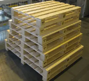 Stack of wooden pallets in a warehouse.