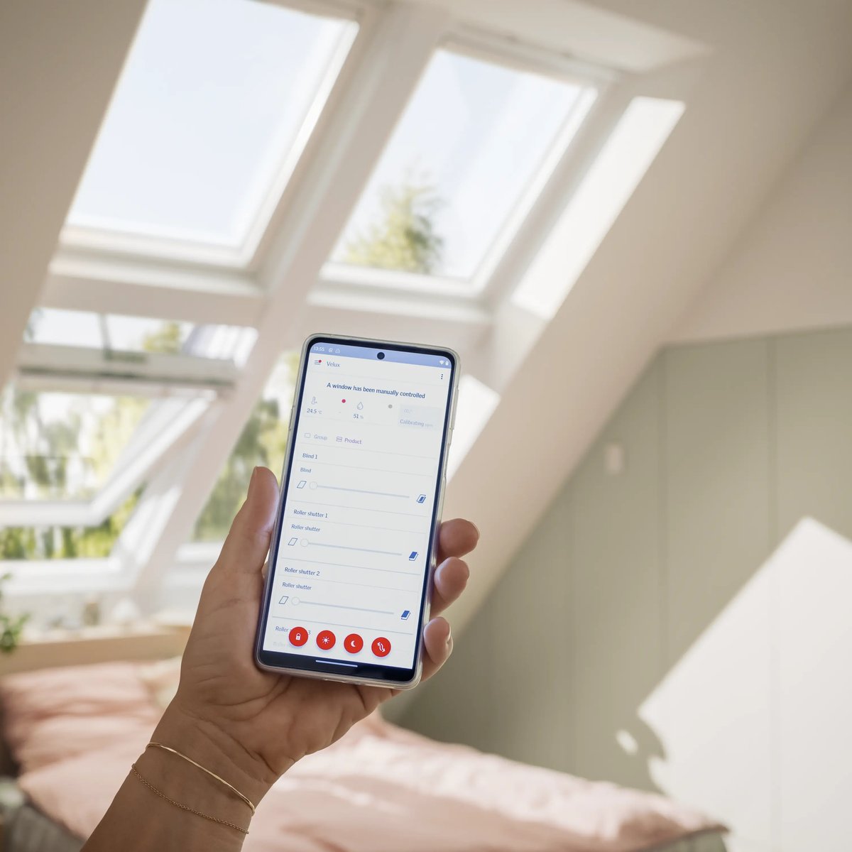Attic bedroom with VELUX roof windows and smartphone control.