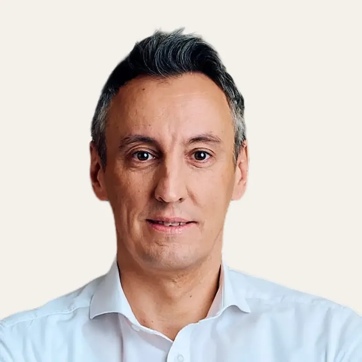Person wearing a white shirt, professional and clean appearance.
