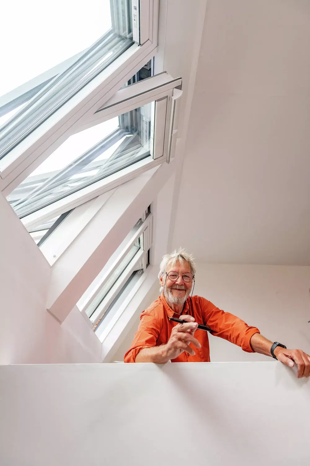 Happy man smiling under his 3in1 VELUX roof windows