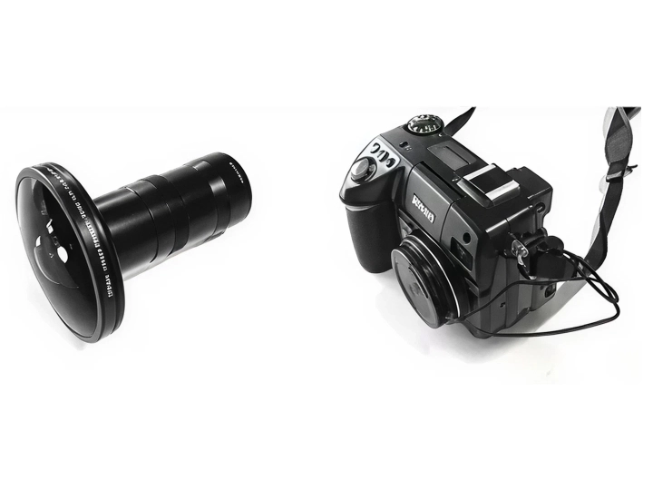 Pentax camera with lens on white background, professional photography setup.