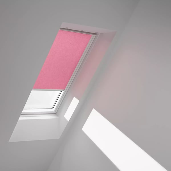 VELUX roof window with pink blind in a sloped ceiling attic room.