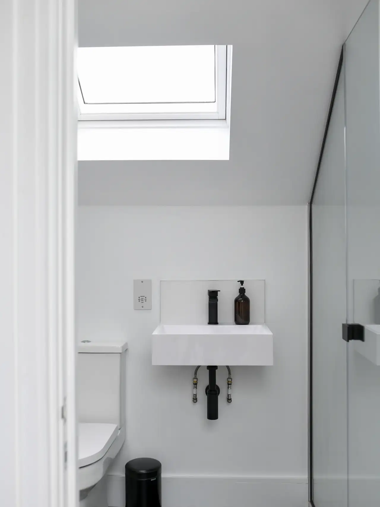 Lavabo bianco con sanitari neri direttamente sotto un lucernario | Rivista VELUX