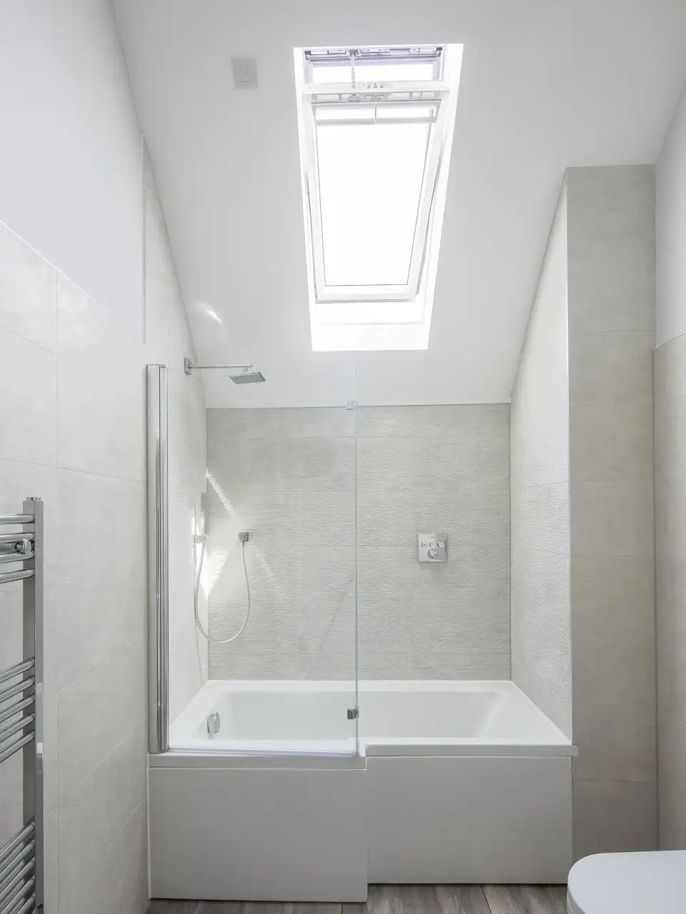 Bathroom with VELUX roof window, modern design, natural light.
