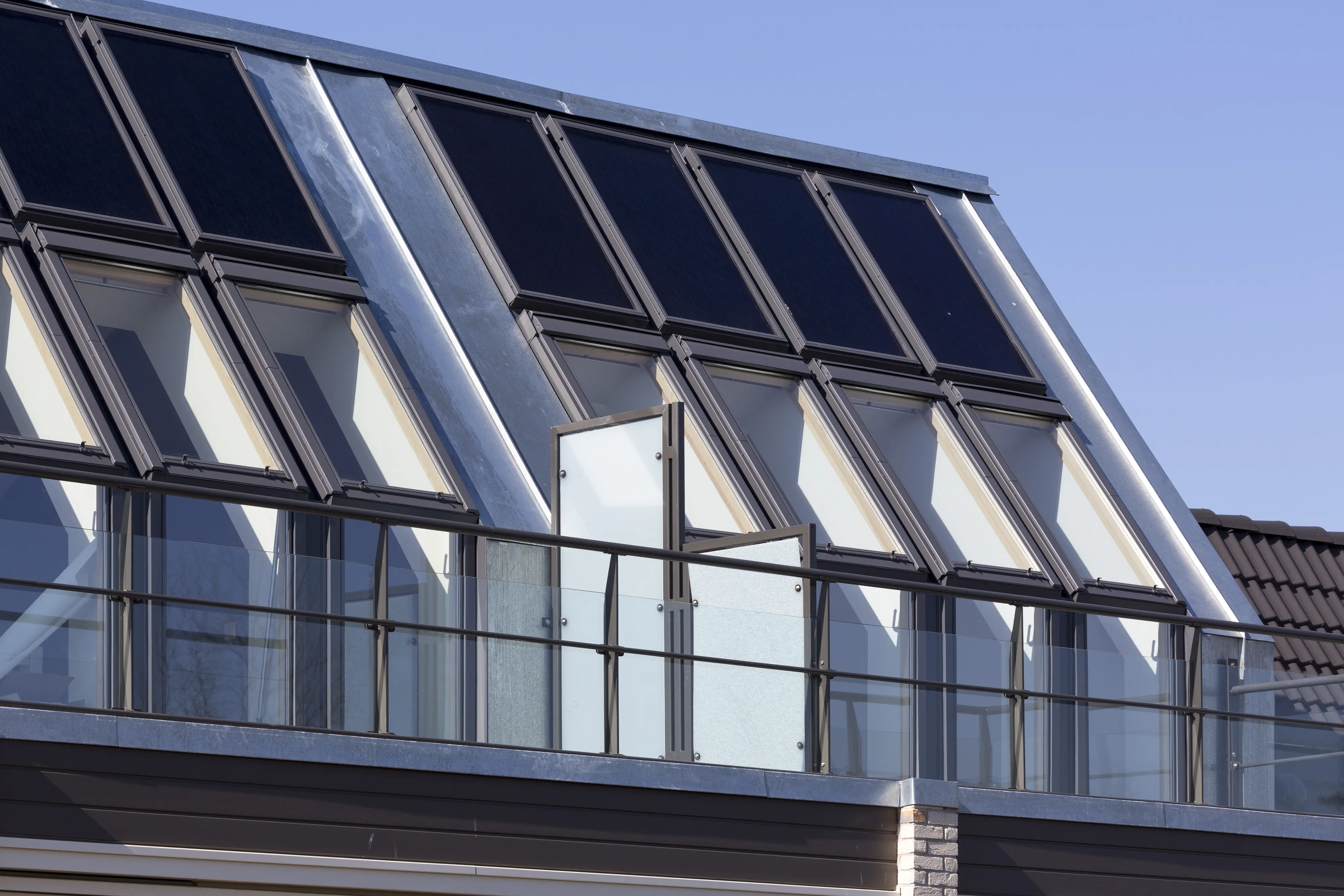 Modern building with VELUX roof windows and steeply pitched roof.