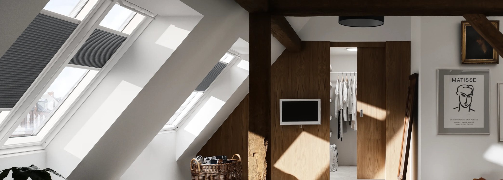Attic bedroom with sloped ceiling, VELUX windows, and walk-in closet.