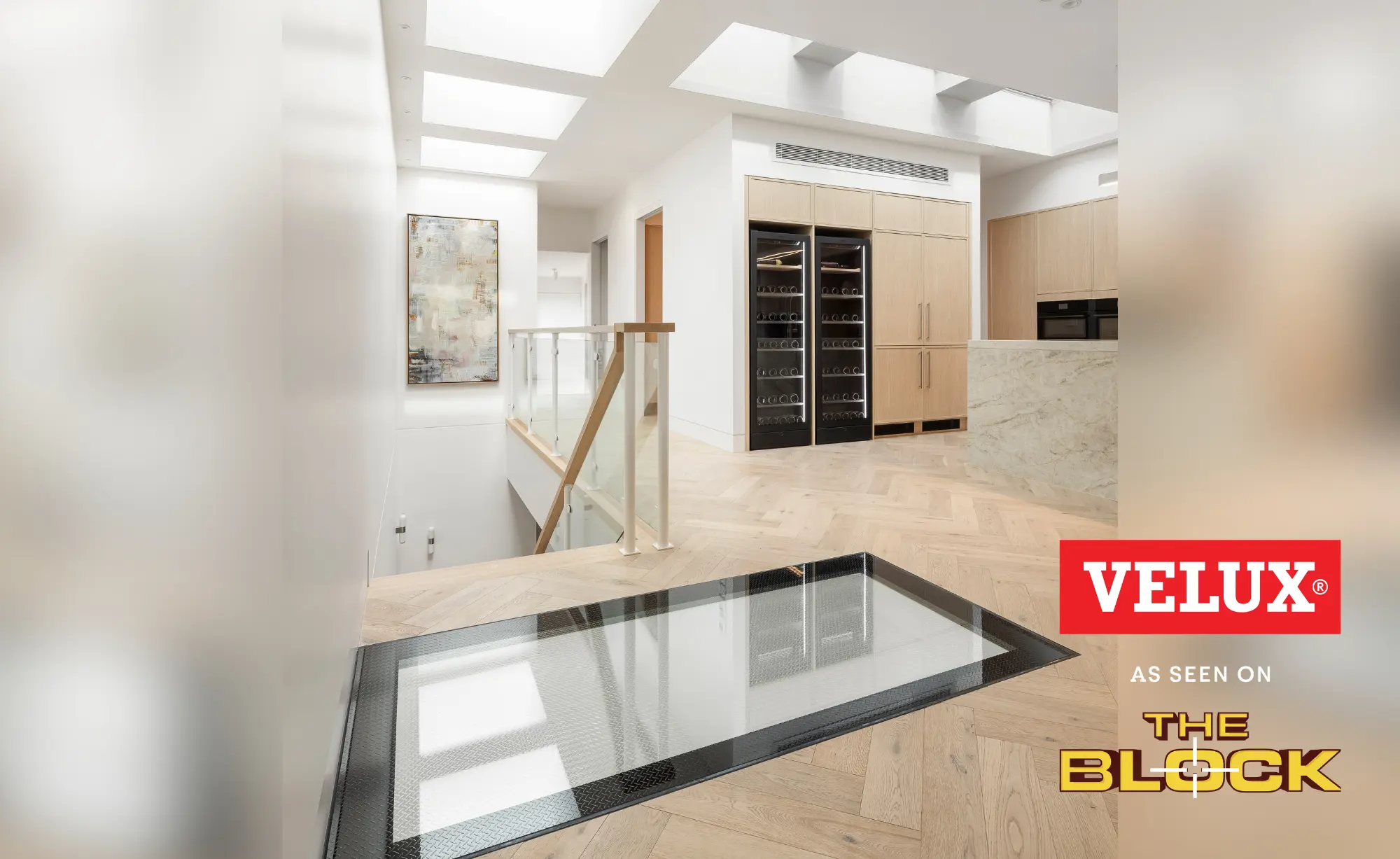 Modern upstairs kitchen and landing lit by multiple VELUX flat roof windows.
