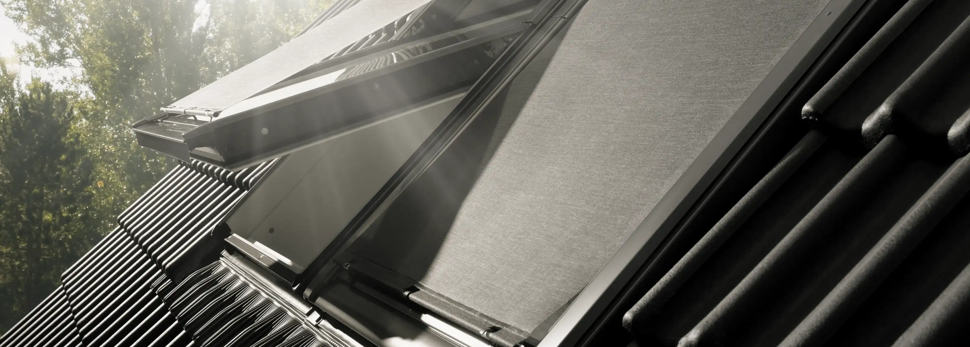 VELUX roof window with open shade, sunlight streaming through.