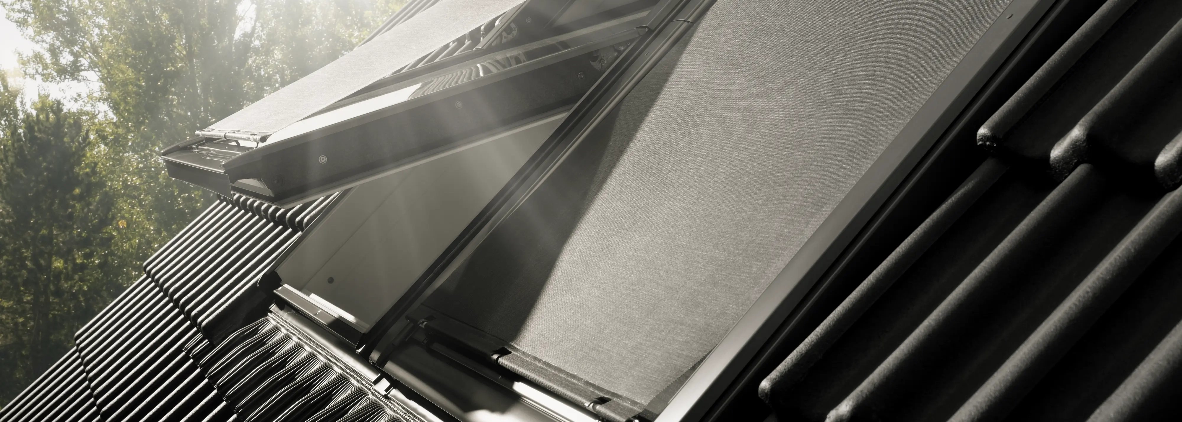 VELUX roof window with open shade, sunlight streaming through.