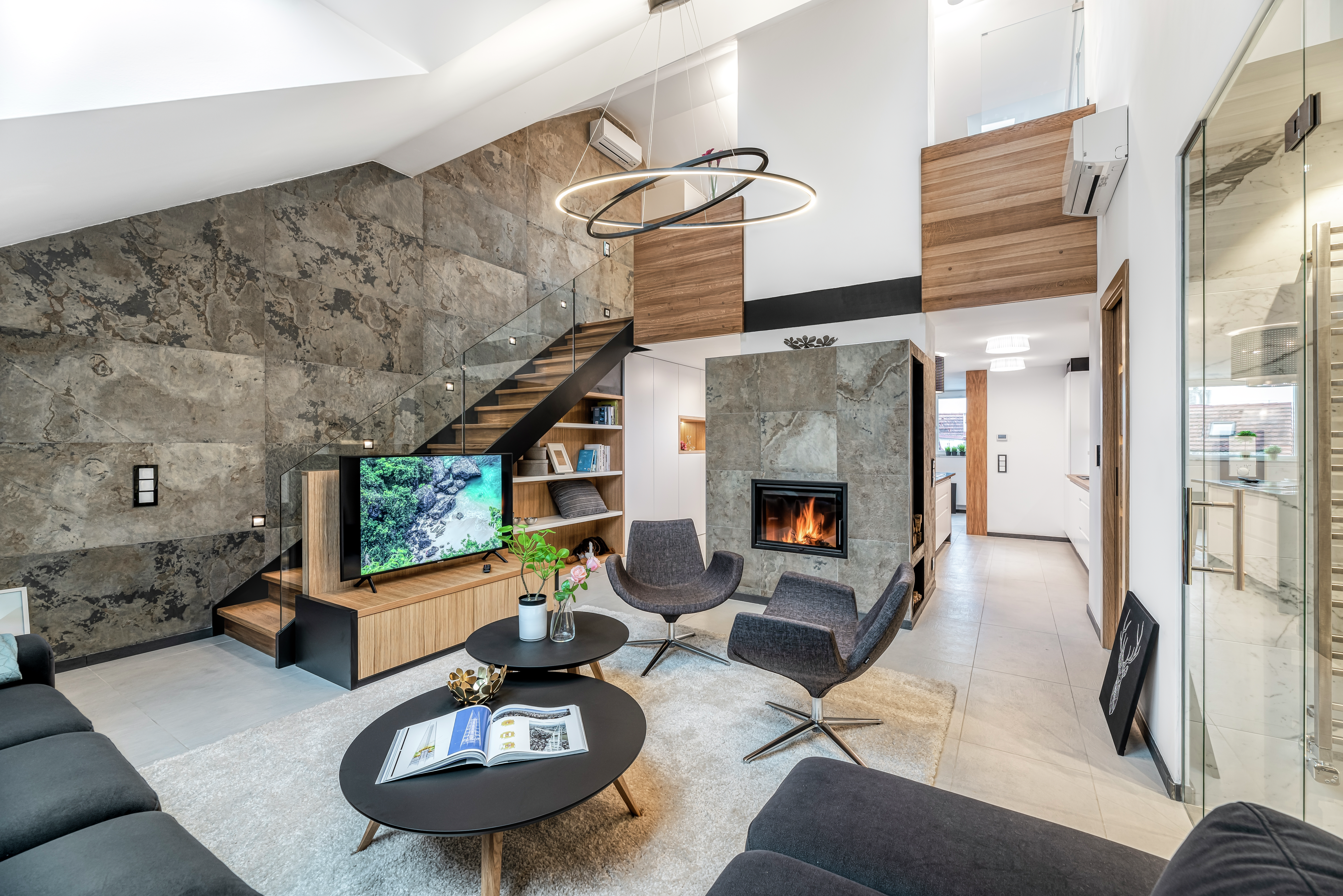 Contemporary living room with fireplace, TV, and modern furniture.