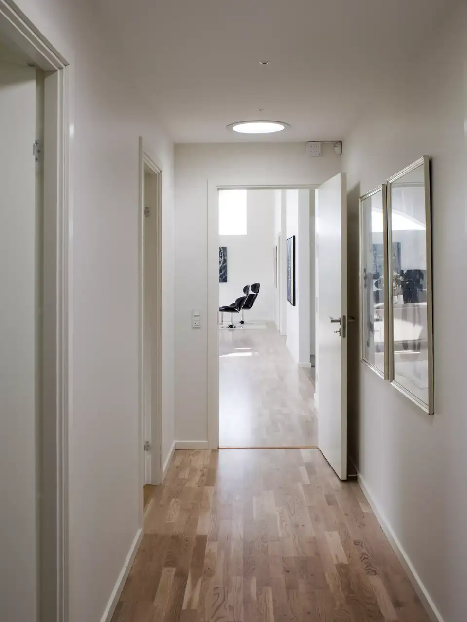 Corridoio interno con pavimento in legno e luce naturale proveniente da un tunnel solare VELUX.