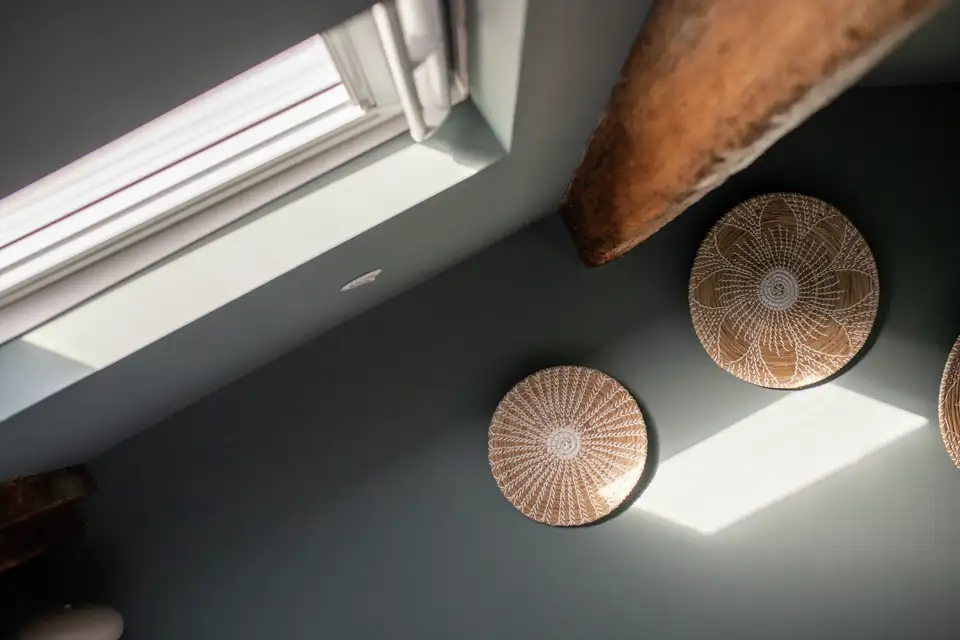 VELUX roof window illuminates a coloured wall in the attic.