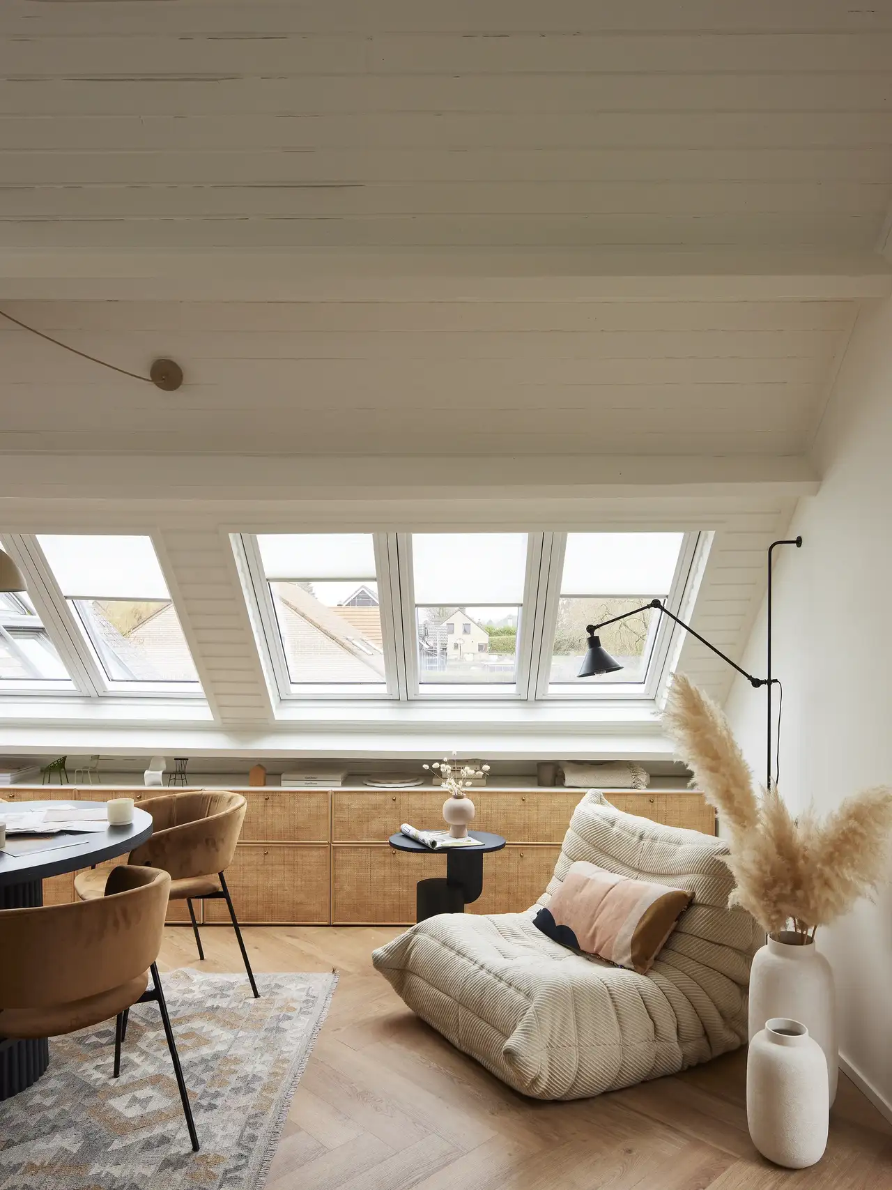 Roof windows fill a living bedroom with daylight after a house renovation 