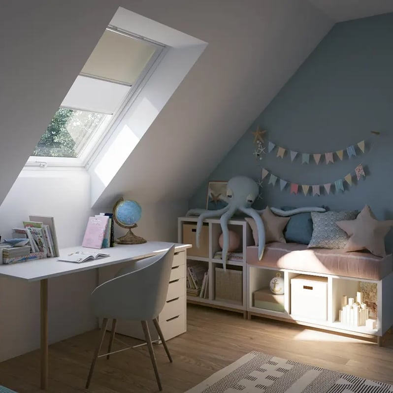 Attic kids room with sloped ceiling and VELUX roof window, playful decor.