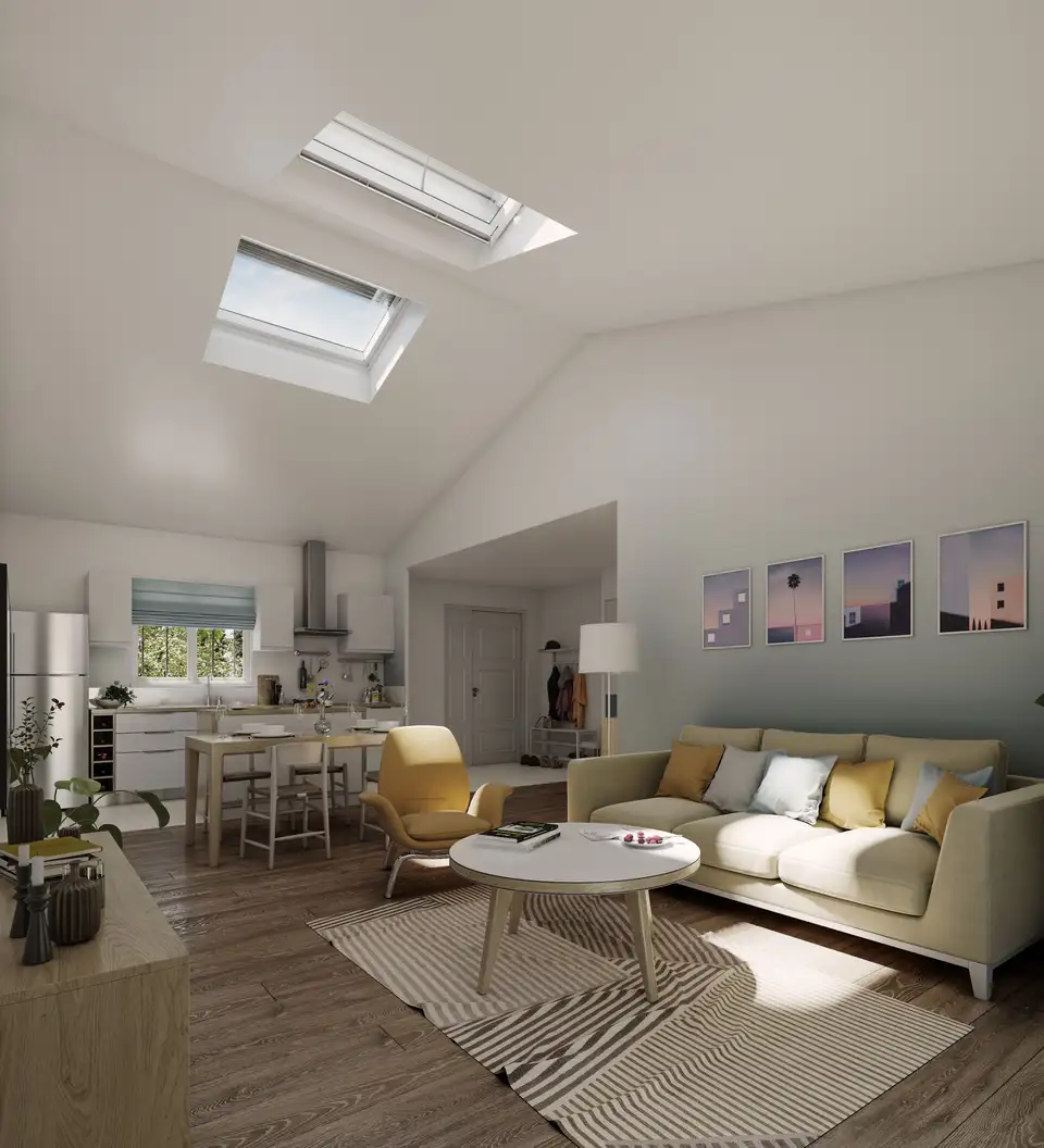 un salon ouvert sur la cuisine bénéficie de la lumière naturelle des fenêtres de toit VELUX  