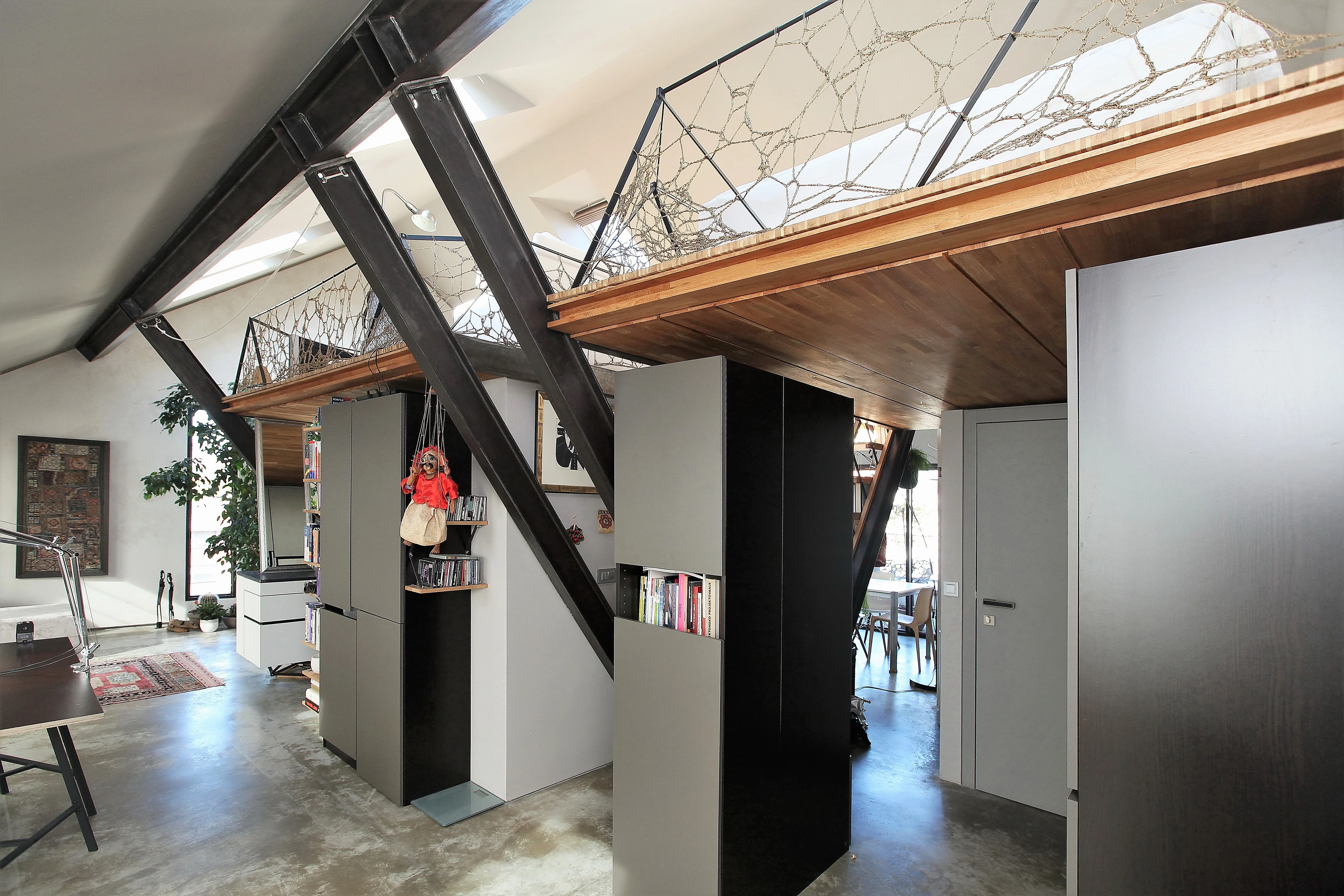 Modern loft with visible rafters and VELUX roof windows, bright interior.