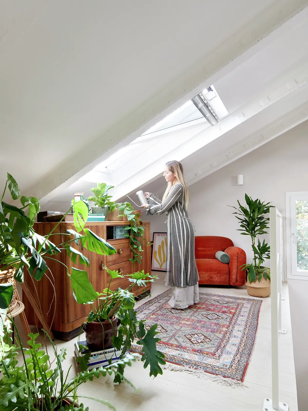 Accogliente stanza per hobby in mansarda con piante, mobili vintage e finestre per tetti VELUX.