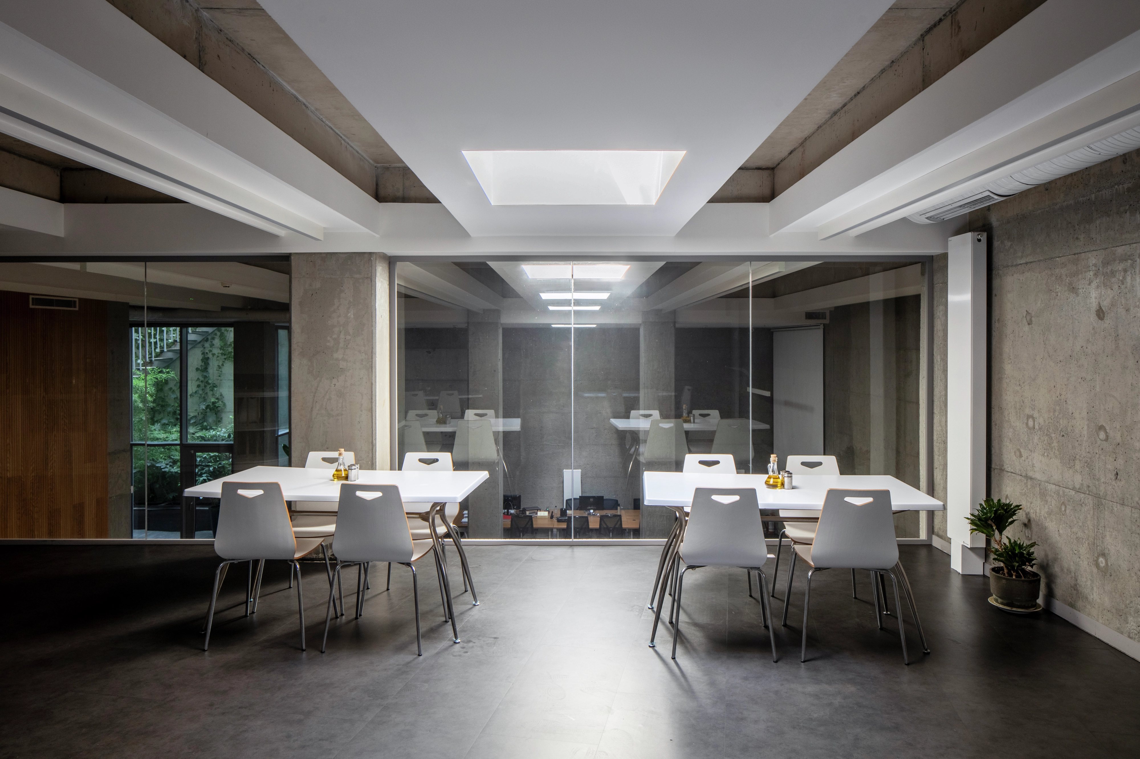 Modern dining area with white furniture and VELUX roof window.