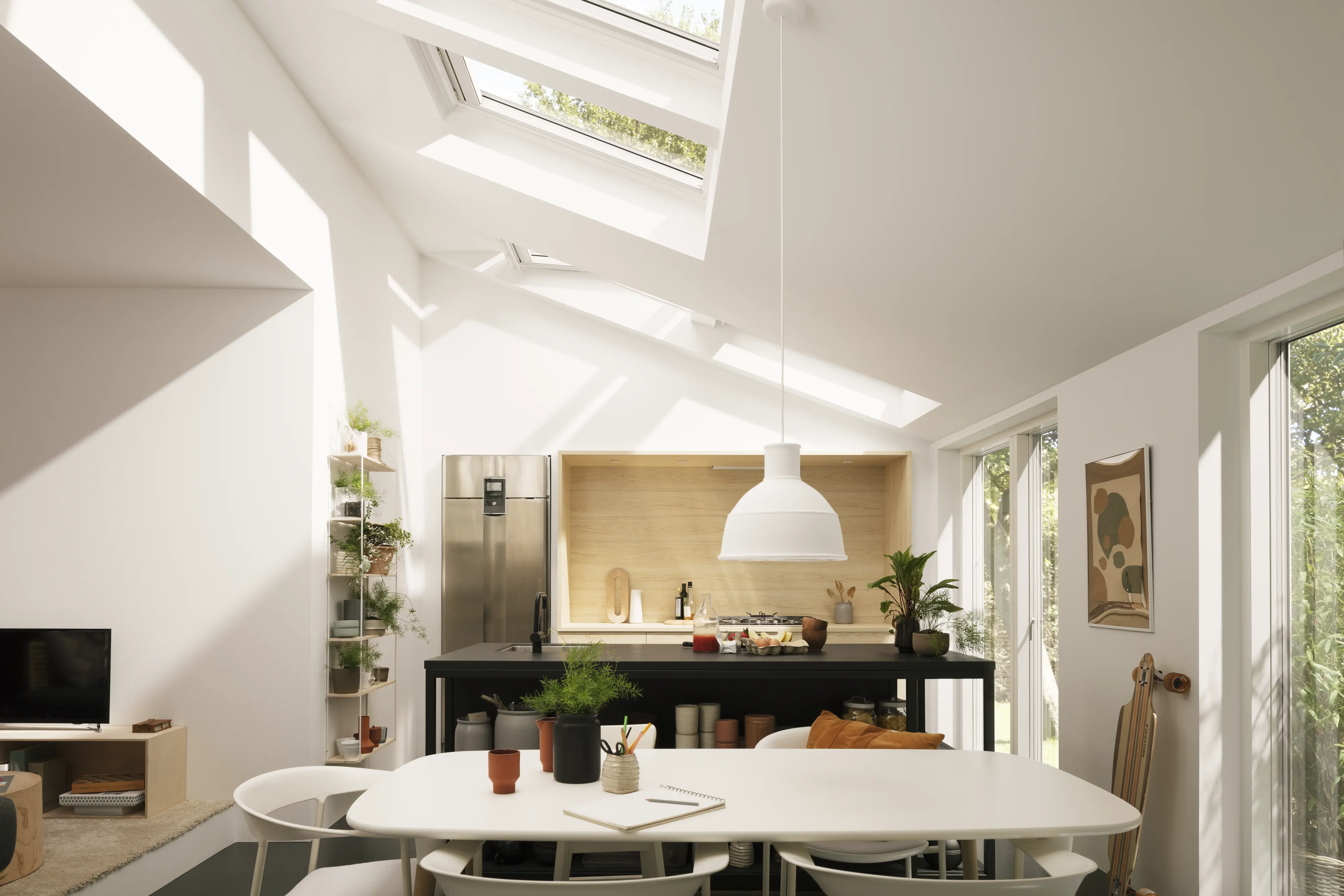 Modern kitchen with VELUX roof windows and stainless steel appliances.