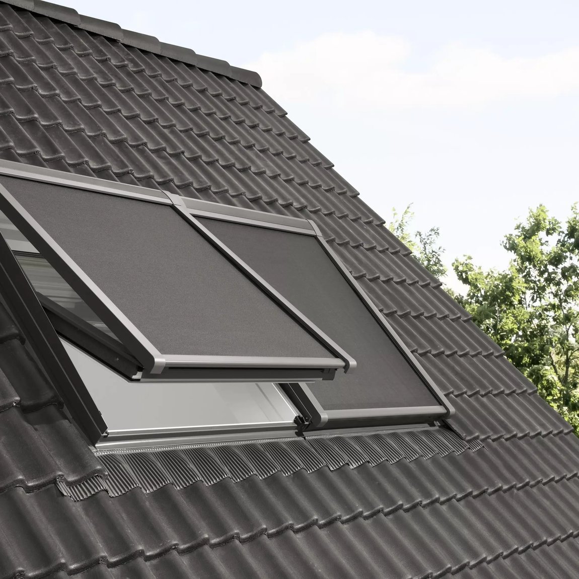 Modern roof with VELUX window partially open, dark ceramic tiles.