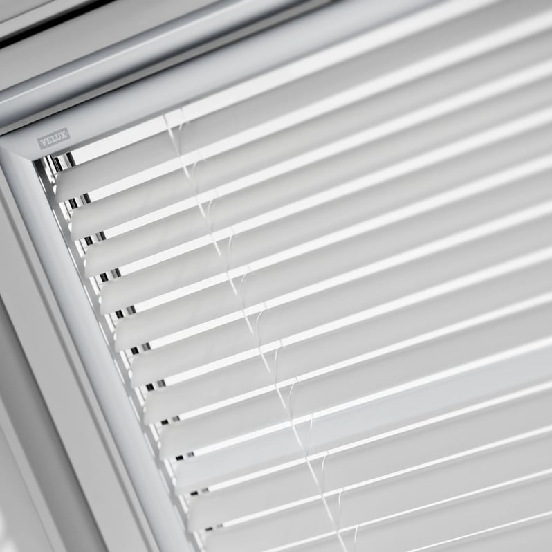 VELUX roof window with white blinds partially open.