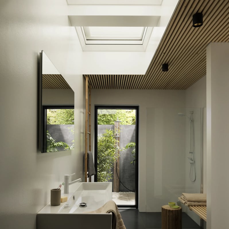 Modern bathroom with VELUX roof window, natural light, and wooden accents.