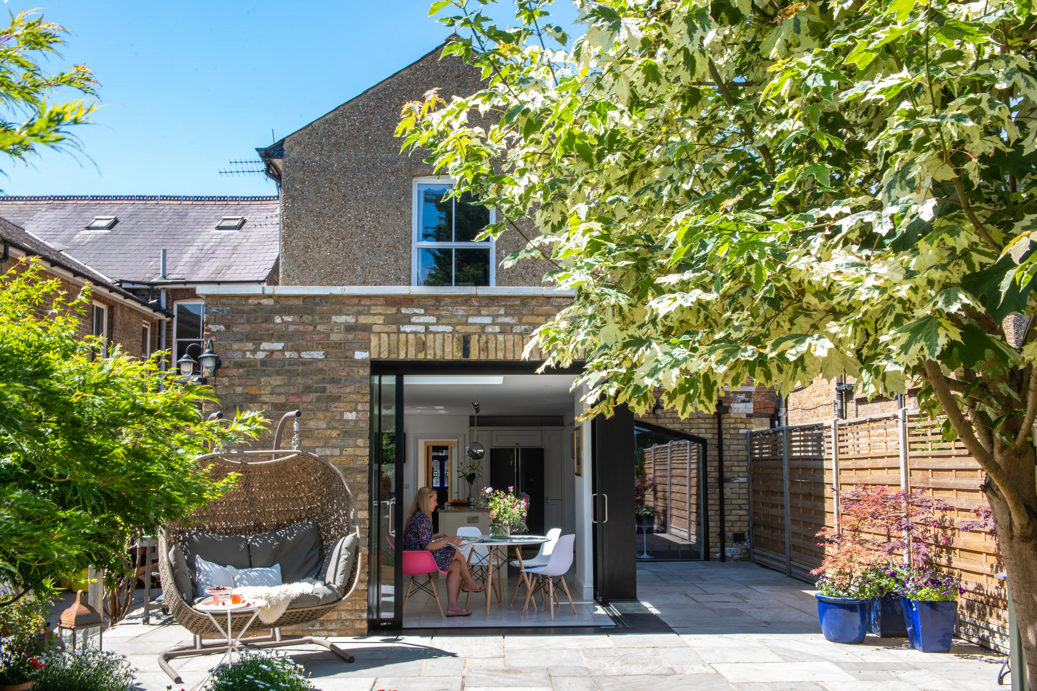 Garden view with modern extension and patio seating.