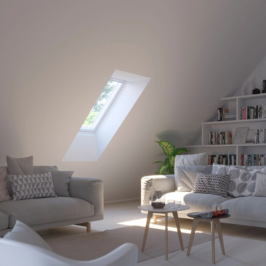 Attic living room with sloped ceiling and VELUX roof window, cozy furnishings.