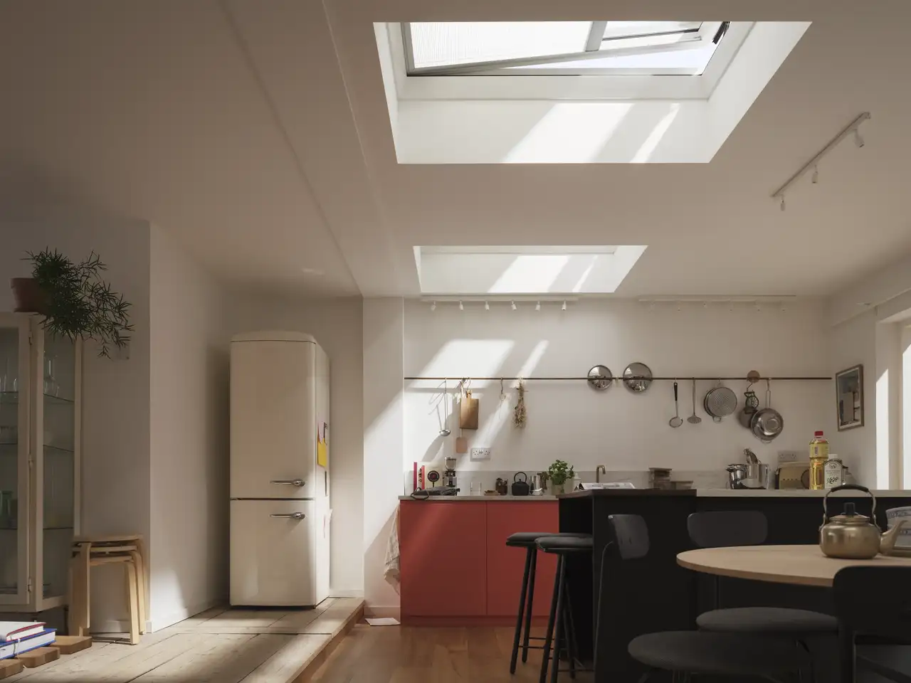 Kitchen in a modern house with VELUX flat rooflight and translucent pleated blind softening natural daylight.
