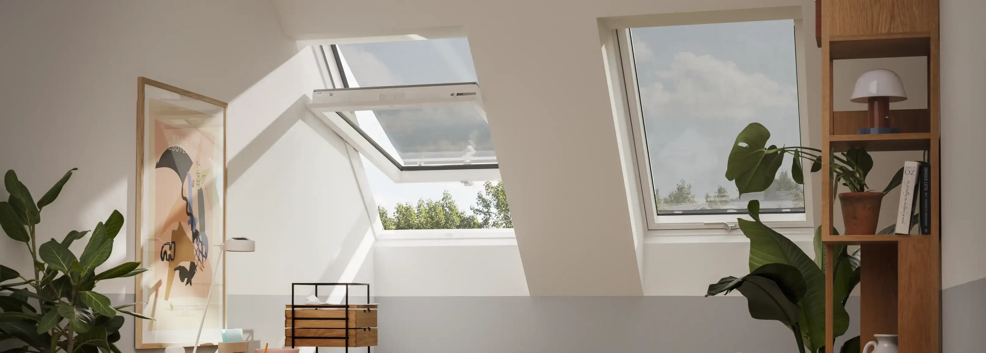 Attic workspace with sloped ceiling and VELUX roof windows, natural light.